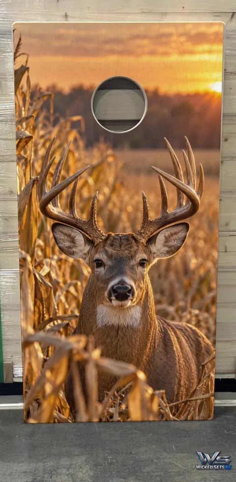 Board printed with a whitetail buck standing in a cornfield at sunset