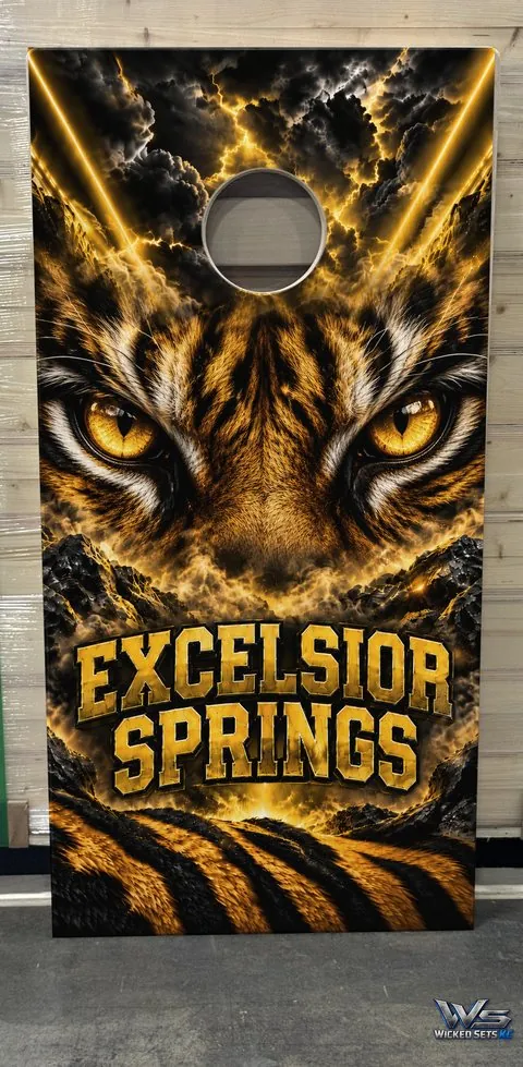 Black and gold board design with tiger eyes above the town name