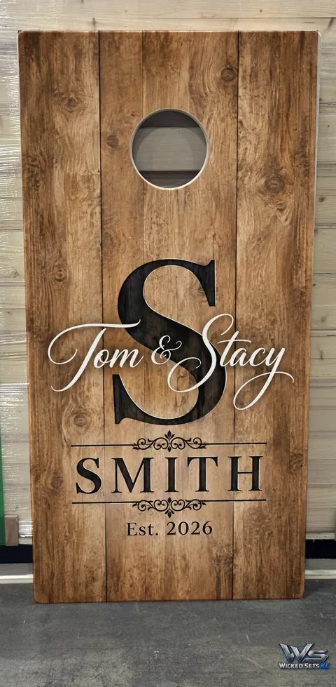 Wedding board design on warm wood with a monogram, first names and a year