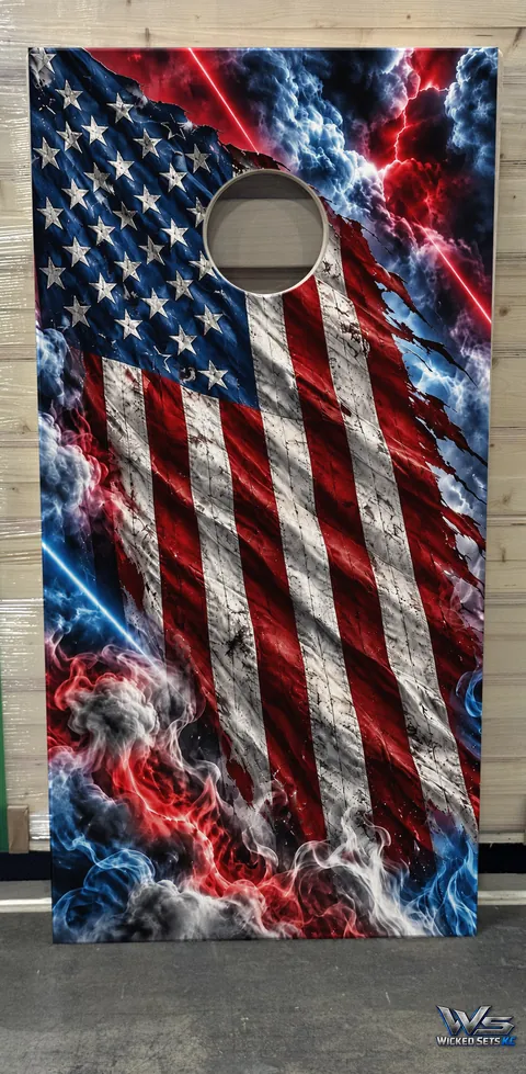Torn American flag in red and blue storm clouds and smoke