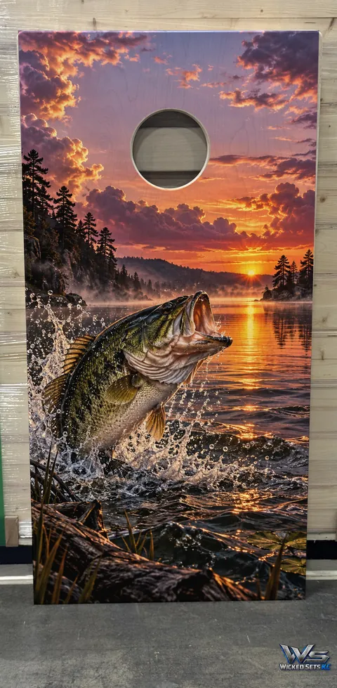 Board design of a largemouth bass leaping from a lake at sunset